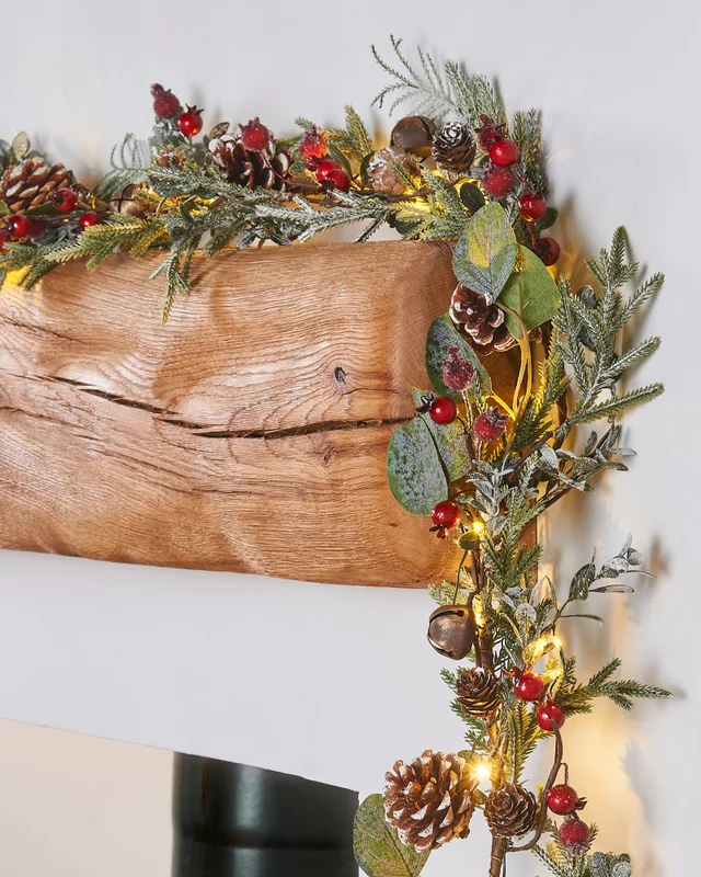 WeRChristmas Green Pre-Lit Frosted Artificial Christmas Garland With Eucalyptus Pinecones And Berries 55 Warm White Leds 9 Ft