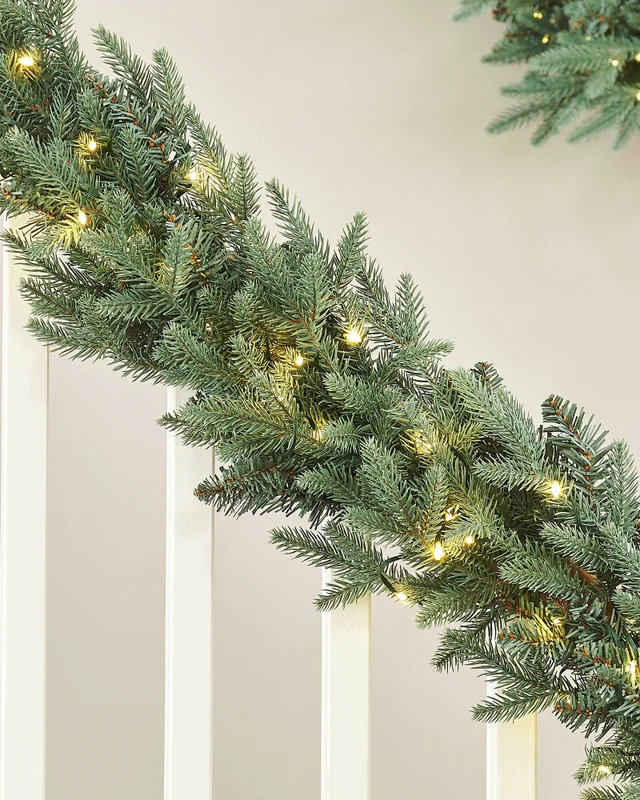 WeRChristmas Blue Pre-Lit Mixed Pine Artificial Christmas Garland 100 Warm White And Ice White Leds 9 Ft