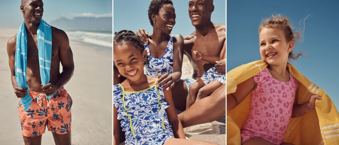 Family wearing matching swimming costumes on the beach with beach accessories