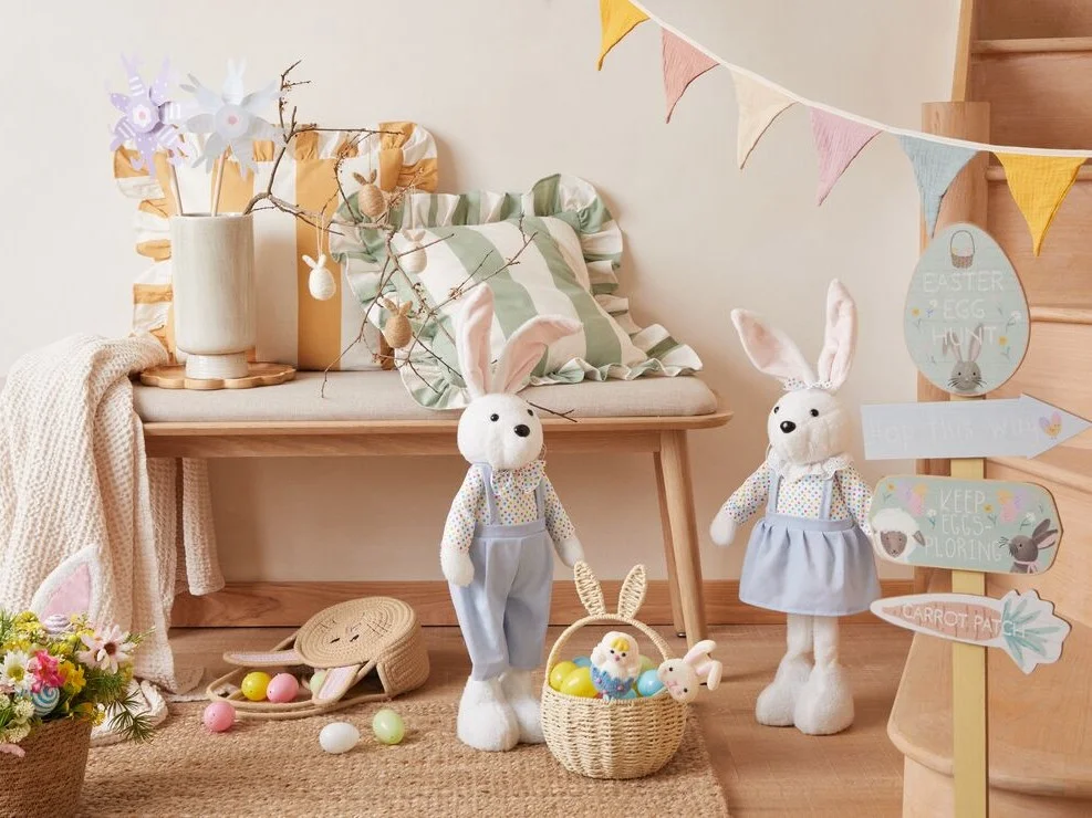 Pastel coloured bunny ornaments with striped Easter eggs.