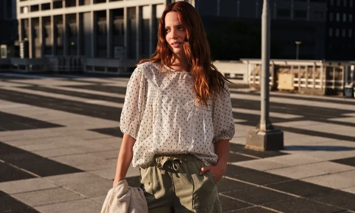 Women wearing blouse and elasticated waist shorts.